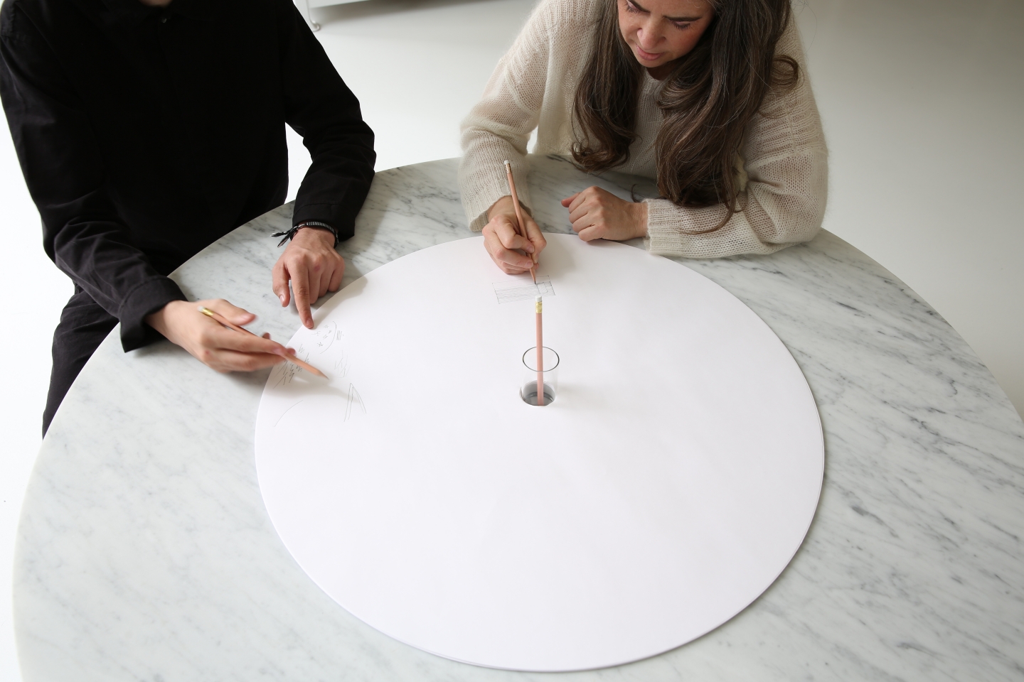 two people draw on molo's sketching circles accessory for cantilever table
