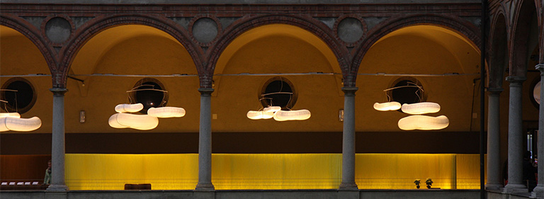 cloud light above illuminated partition walls. Pantone 100 C yellow custom colour textile softwall by molo.