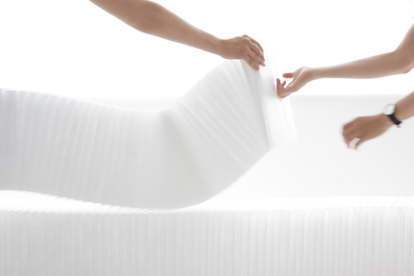 two women arrange a textile softblock - moveable modular room divider by molo