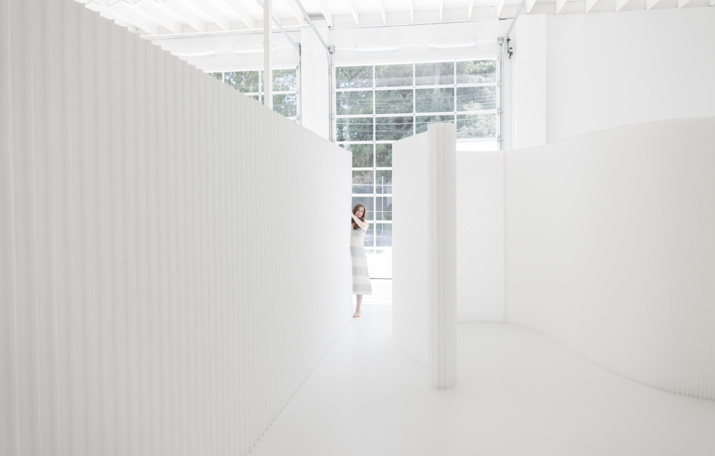 a sculptural installation of white textile softwalls - moveable wall partitions by molo