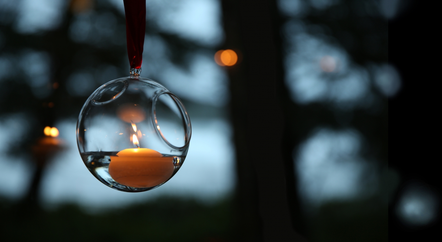 an illuminated candle burns in float bubble