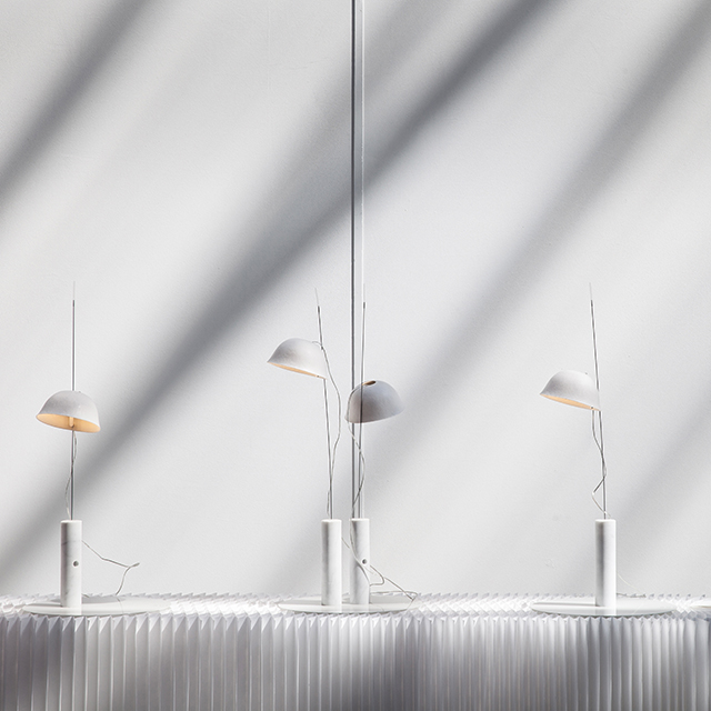 cappello light / table lamp by molo - shadows fall across four cappello arranged along a white textile softblock