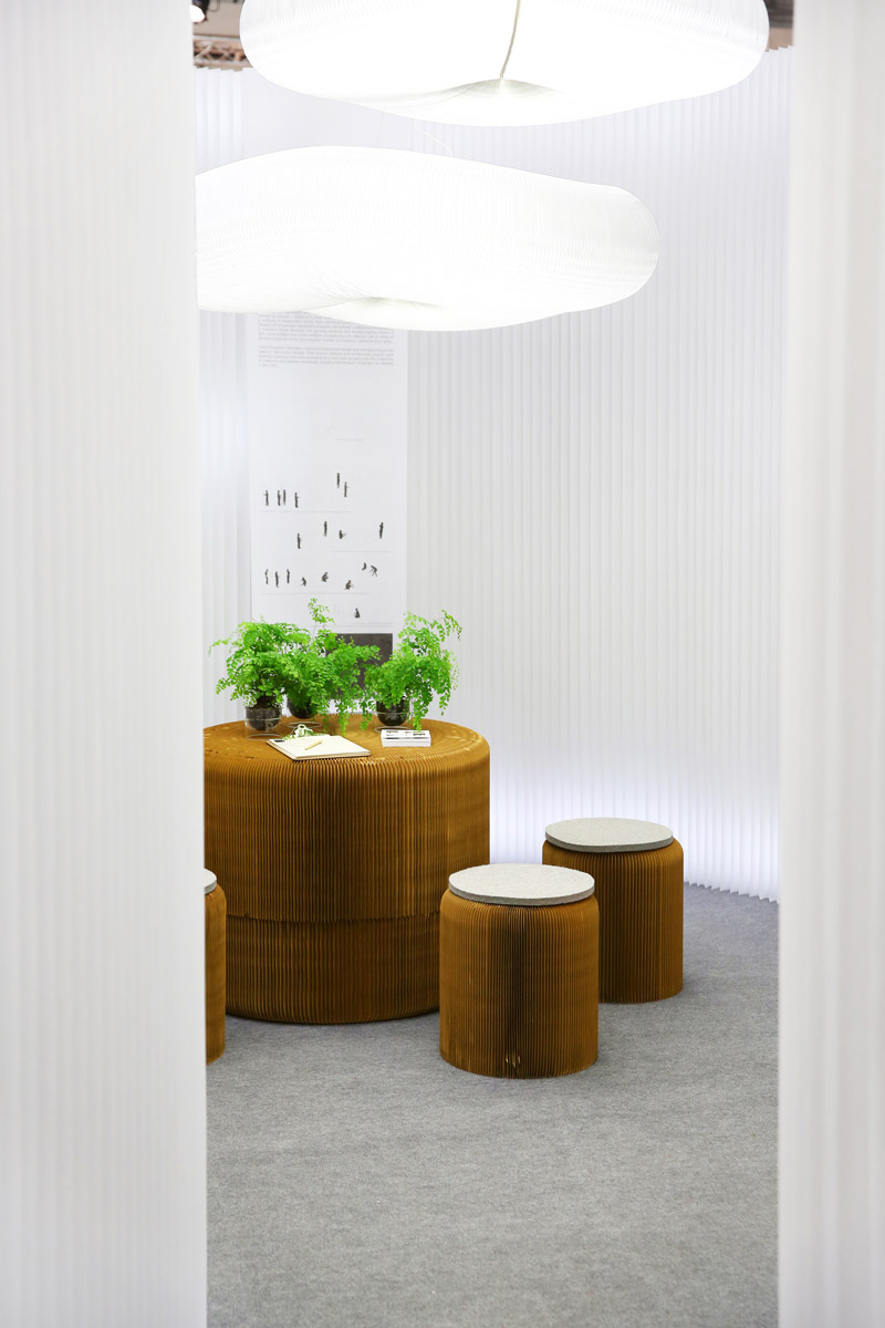 a meeting room made from softseating, modified textile softwall and a cloud - white modular textile wall partitions / cloud acoustic pendant lighting by molo