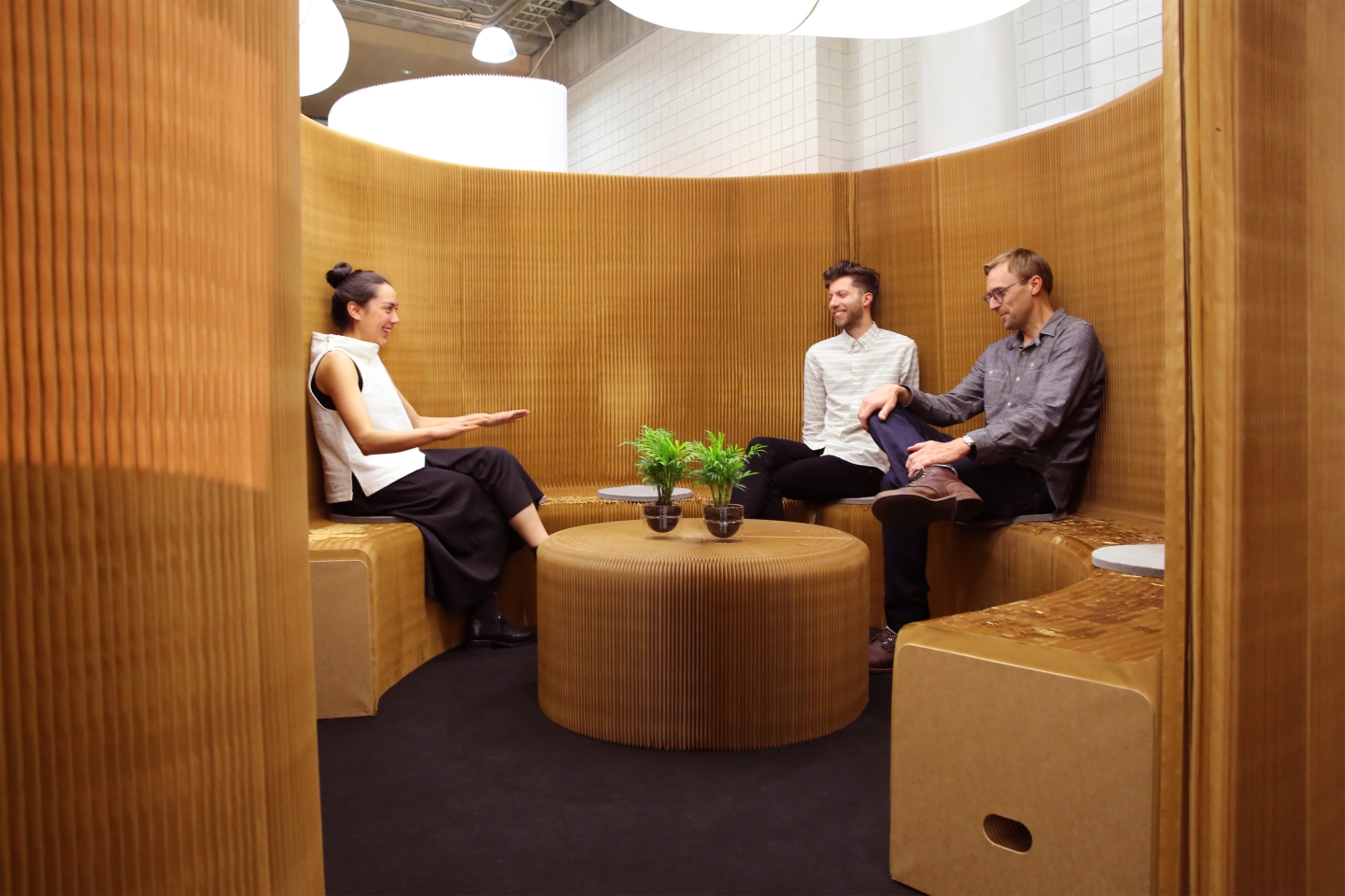 portable acoustic paper furniture by molo - coworkers chat in a meeting room made from benchwall at ICFF