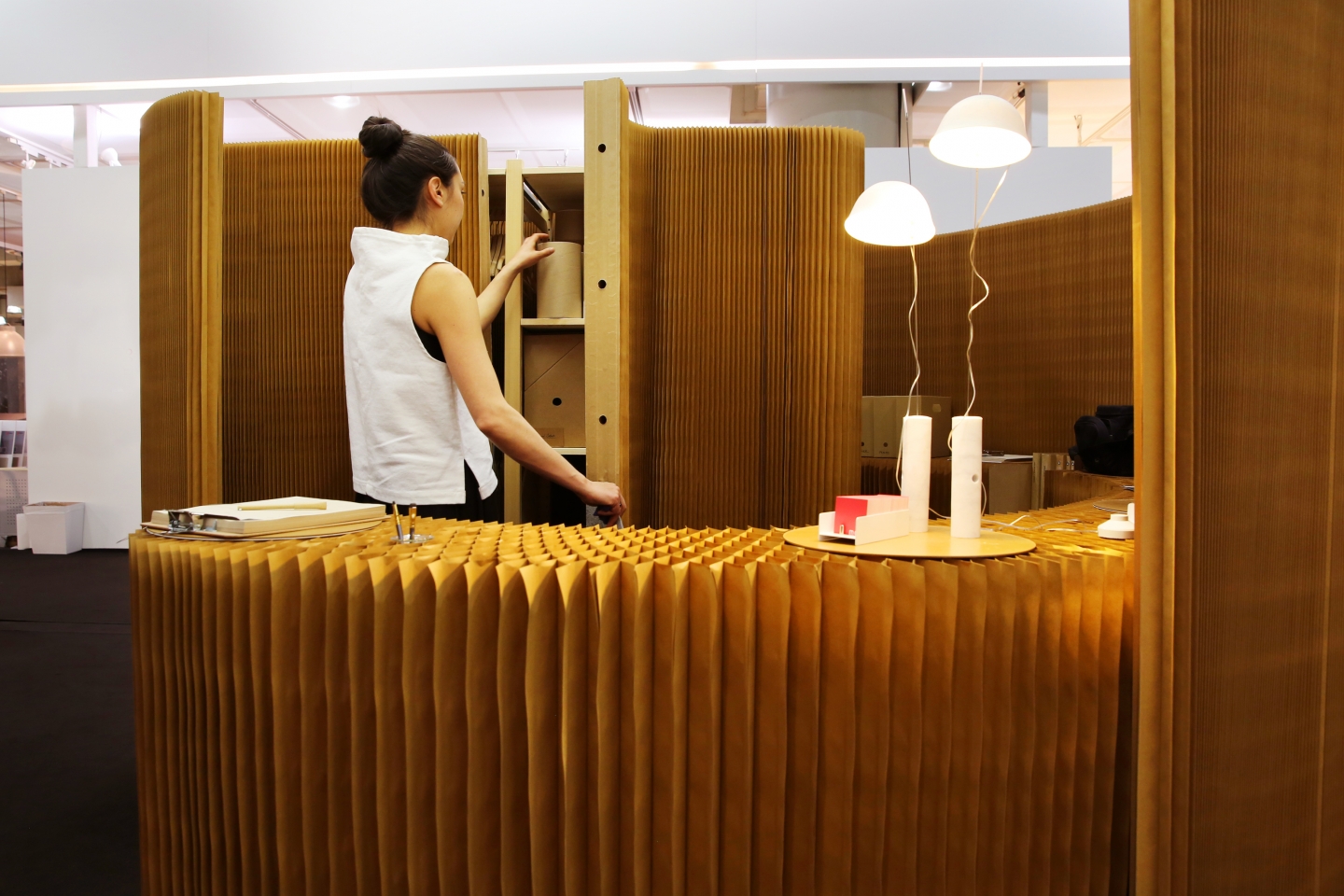 cappello lamps, thinwall / acoustic wall liner and cabinet enclosure by molo - a molo employee retrieves materials from inside a thinwall closet